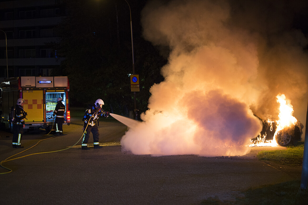 Räddningstjänsten släcker bil som står i brand