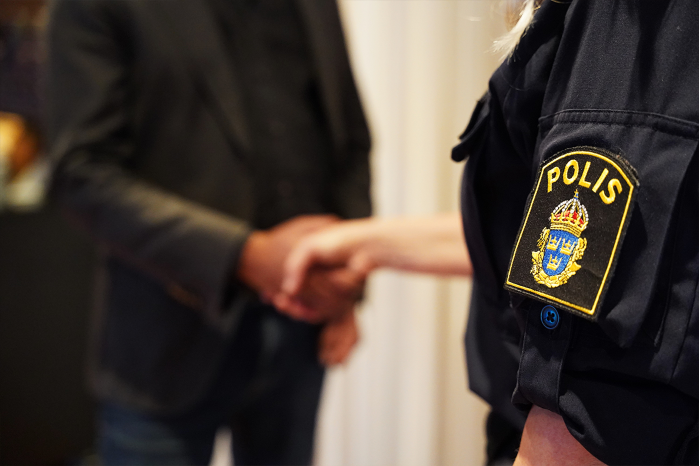 Inzoomad bild på lokalpolisområdeschef Petra Hinterthaner och Luleå kommuns vice ordförande för kommunstyrelsen Fredrik Hansson som skakar hand.