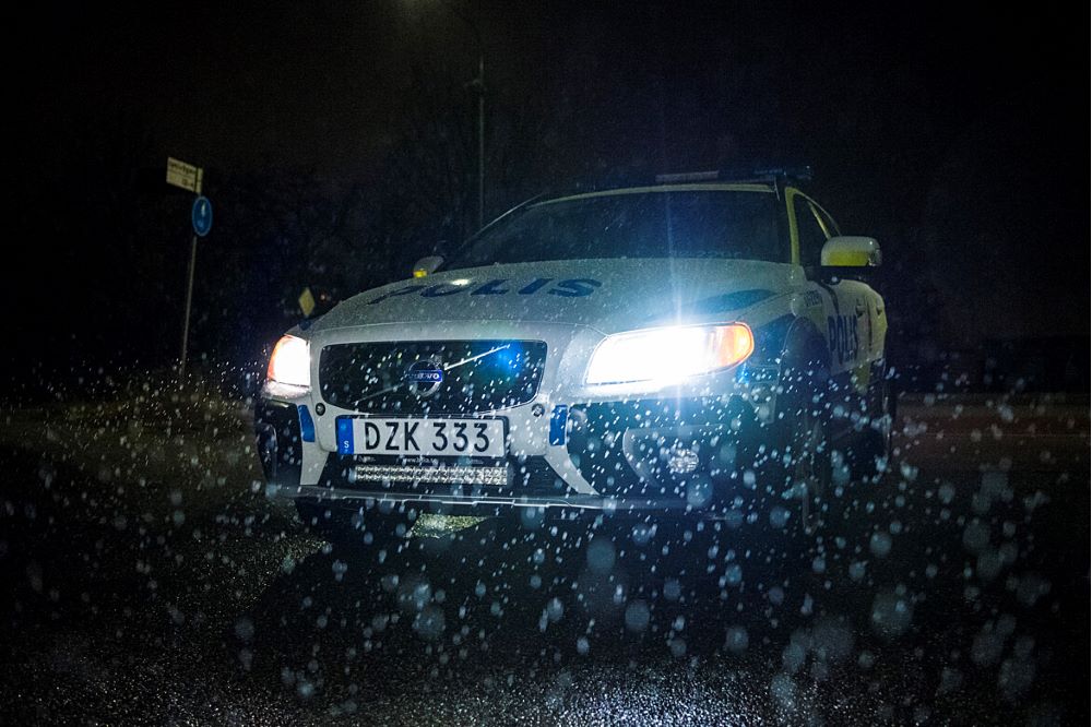 Bild på polisbil i regn vid mörker