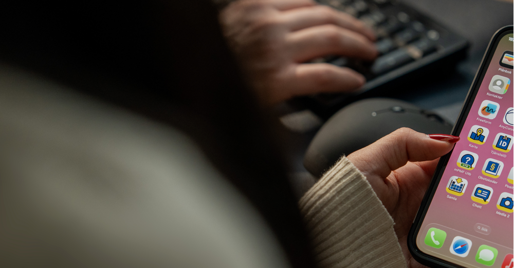 Kvinna håller i en mobiltelefon